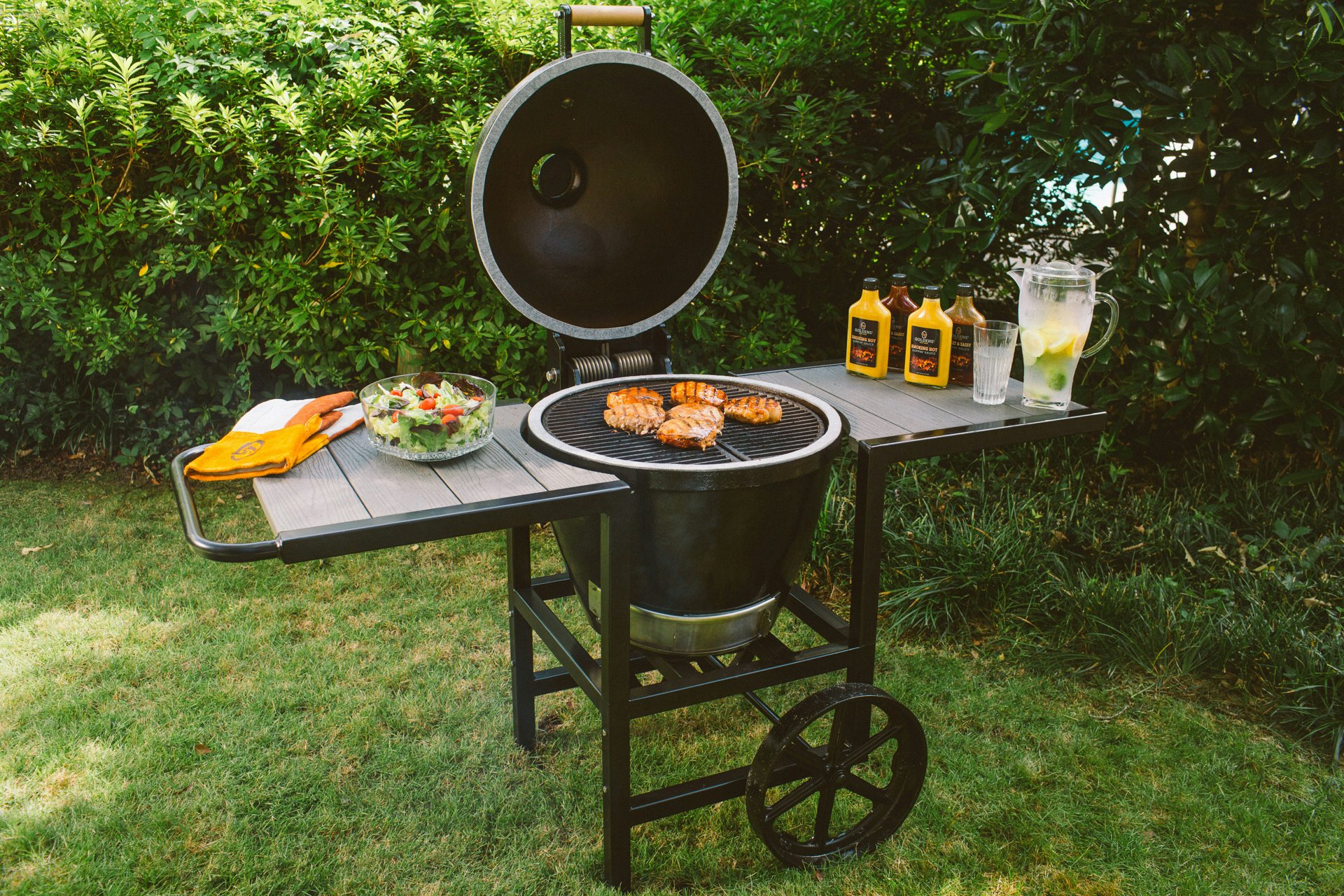 Family BBQ gathering in garden with grill and outdoor furniture