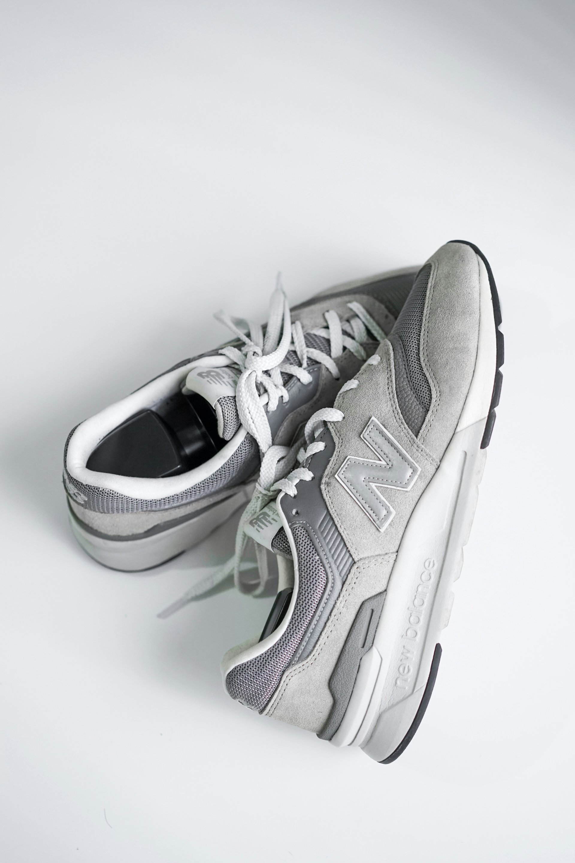 Grey New Balance running shoes on clean white background