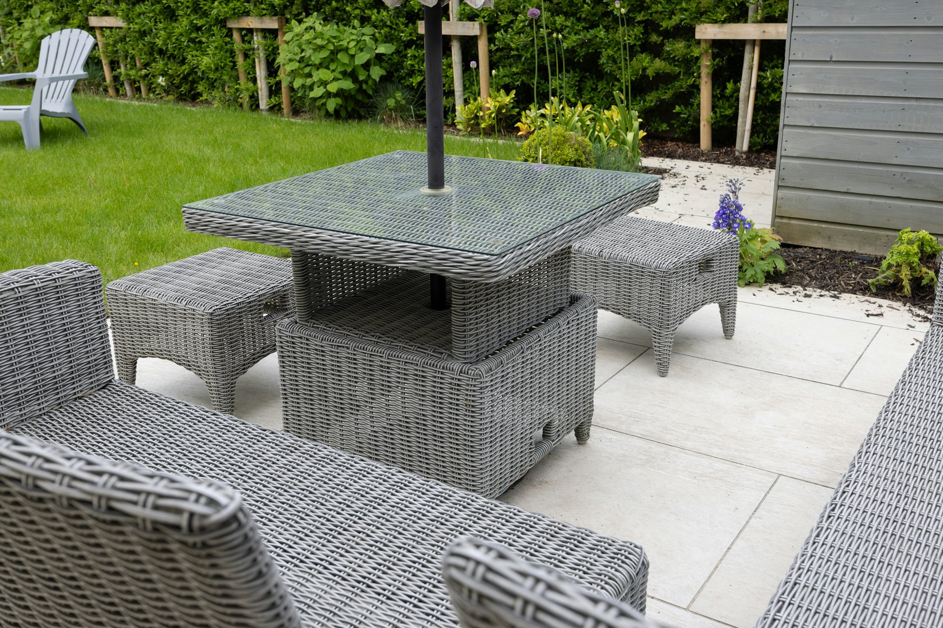 Rattan garden furniture set with four chairs and table on a patio